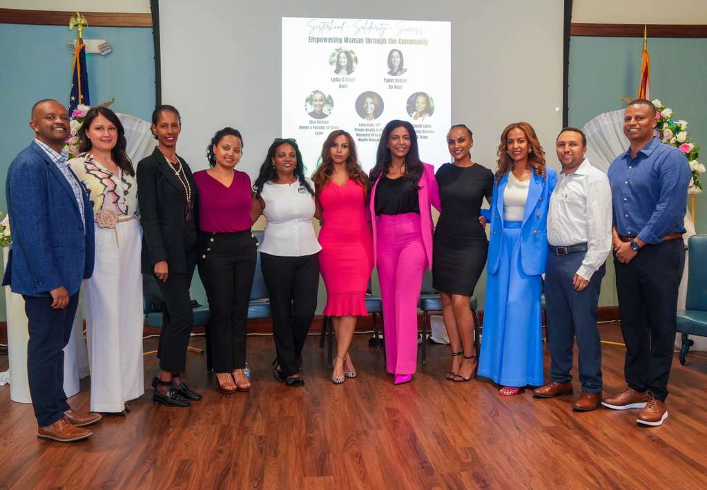 Community leaders, speakers, and organizers gather after the event.